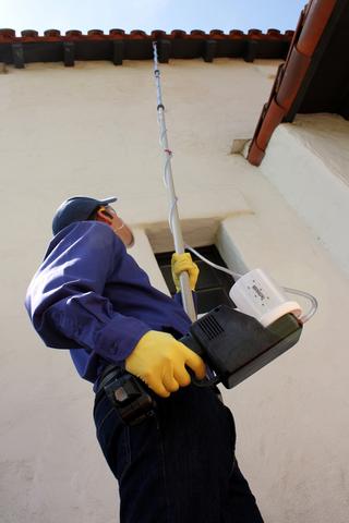 Specialists using a power duster outside home